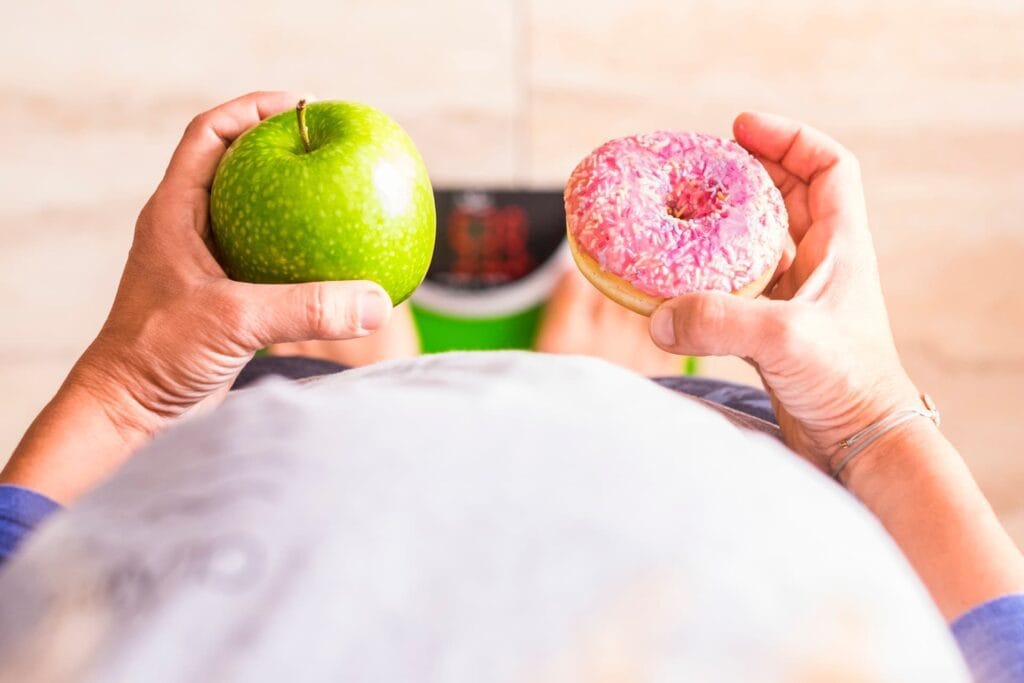 woman look at donut and apple to select her nutrit 2025 03 09 06 32 21 utc